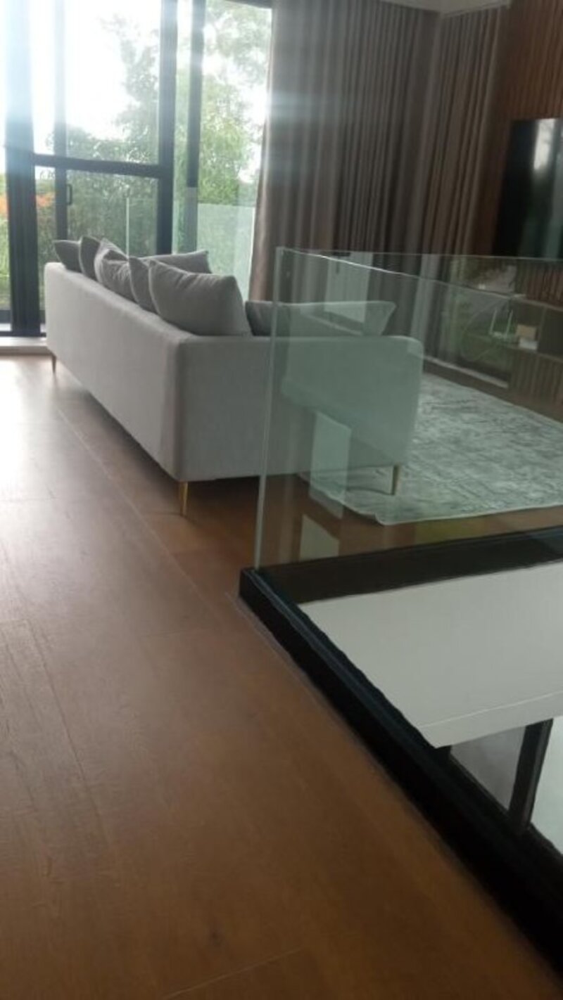 Premium dark wood flooring with floor-to-ceiling windows