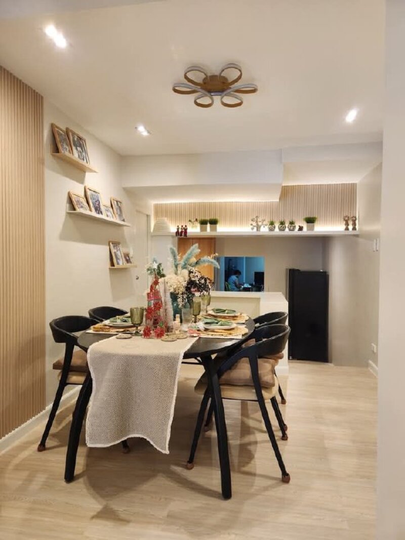 Modern dining room with light wood flooring and slatted accent wall