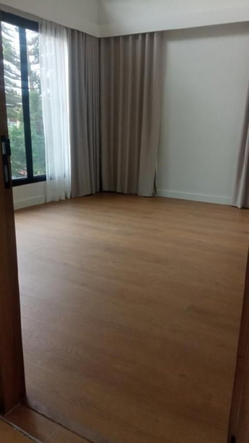Empty room showing clean wood flooring installation with natural light