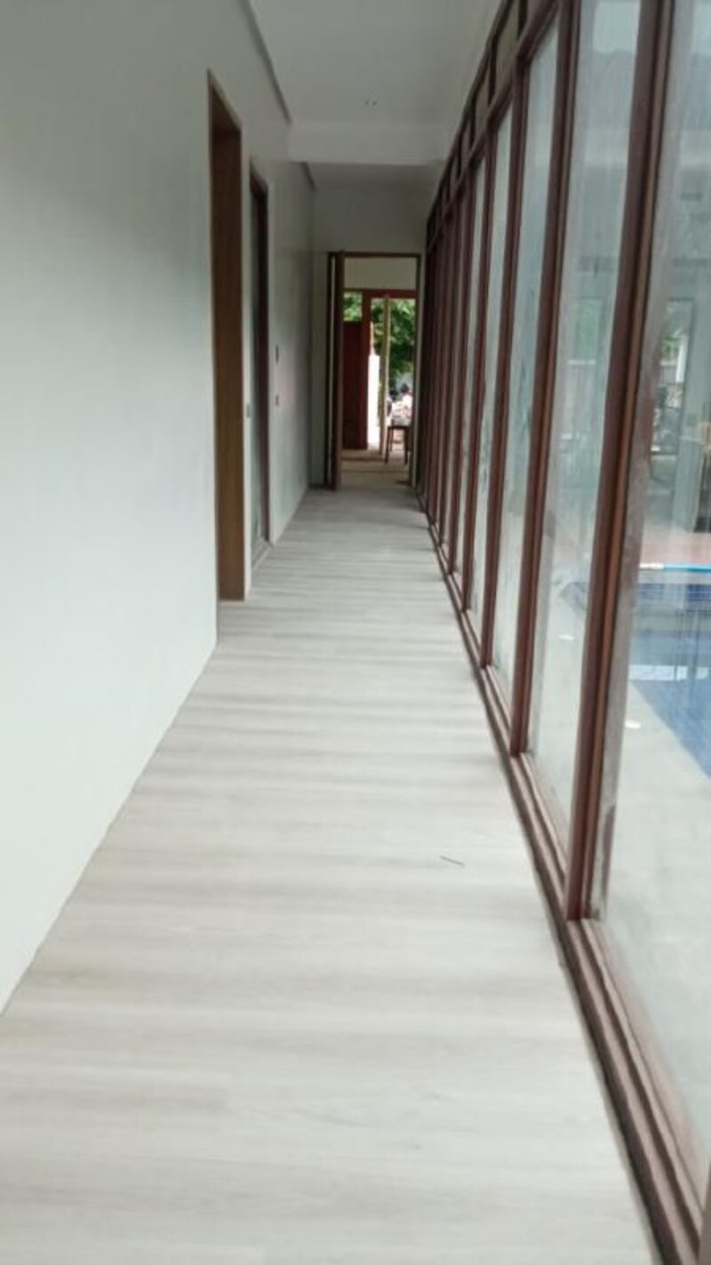 Hallway with light gray whitewash wood flooring
