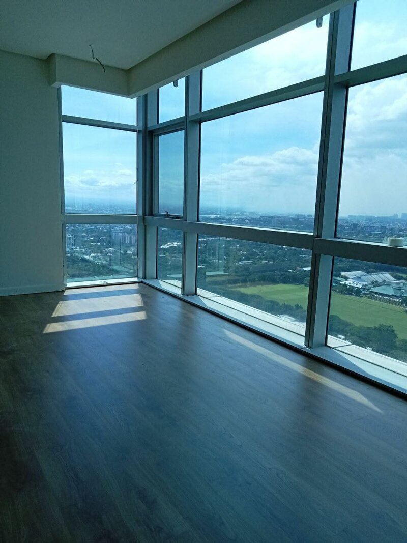 High-rise condo with dark wood flooring and skyline view