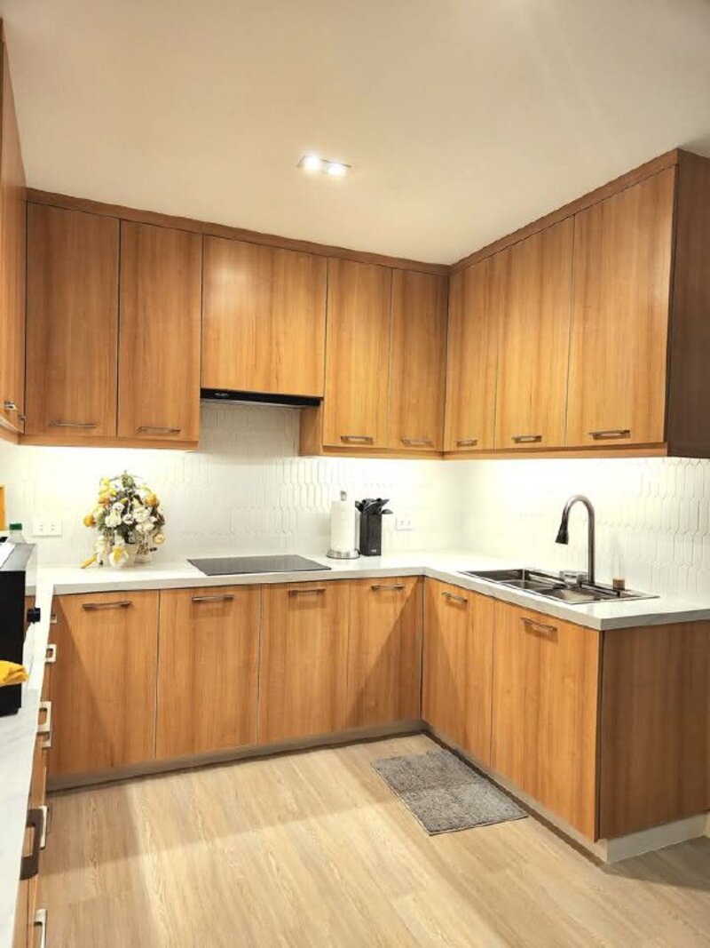 Kitchen renovation with warm wood cabinets and white countertops