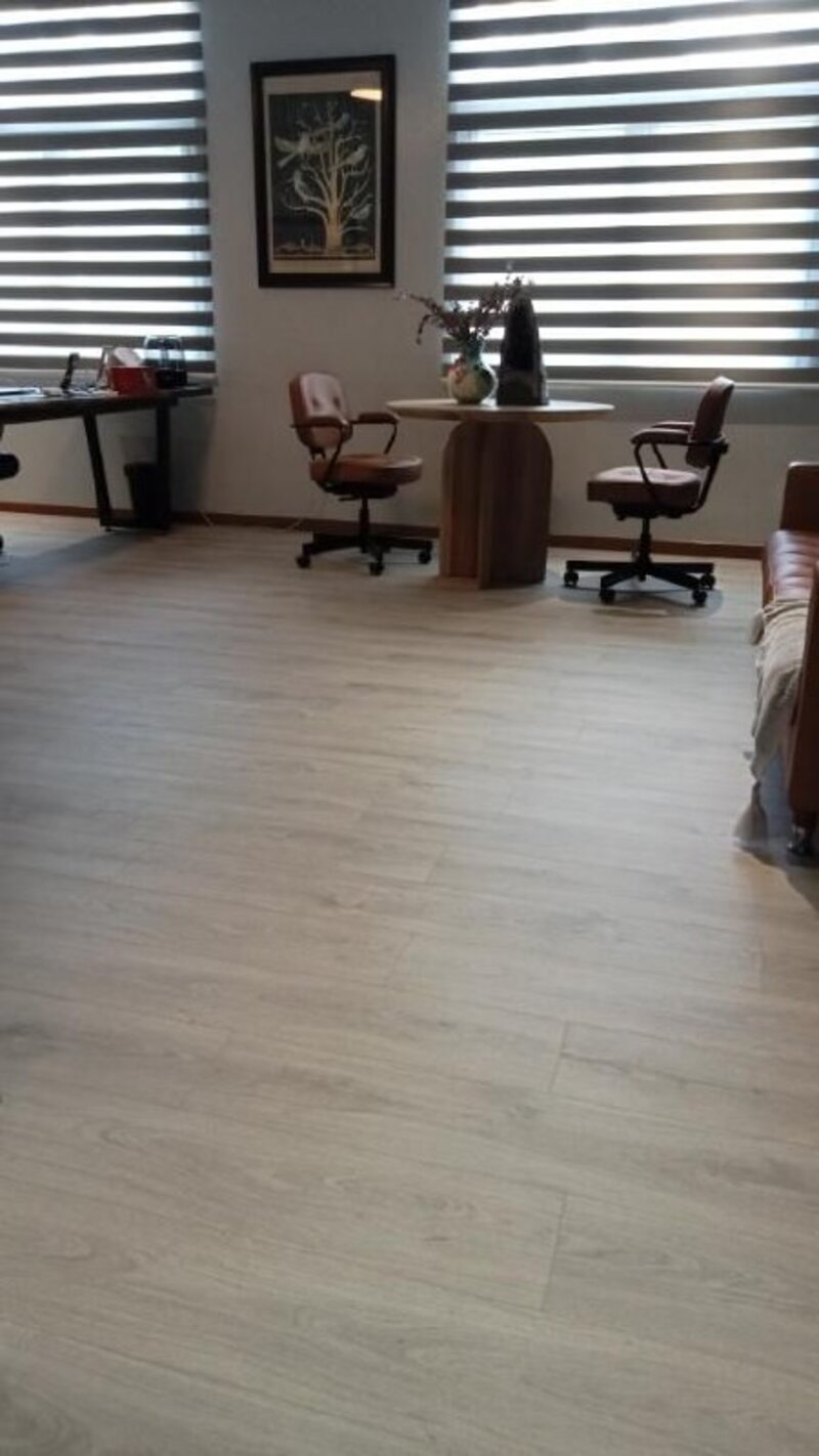 Commercial office space with light wood plank flooring