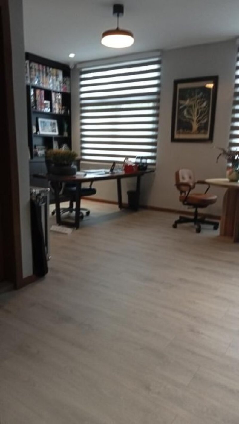 Office workspace with wood flooring from different angle